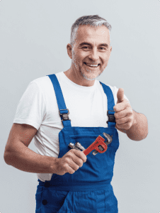 plumber is smiling and holding plumbing key in the right hand
